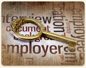 Key on a wood table surrounded by human resources buzzwords