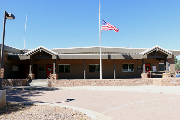 Main building with flag at half mast